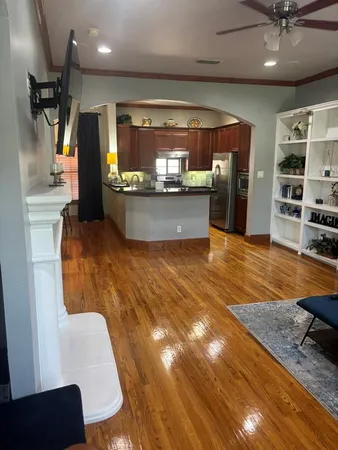 a view of kitchen with stainless steel appliances kitchen island granite countertop a refrigerator and a stove