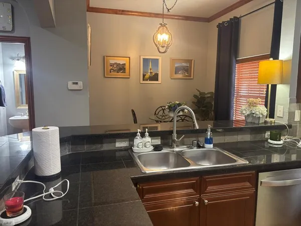 a kitchen with a sink and a stove top oven