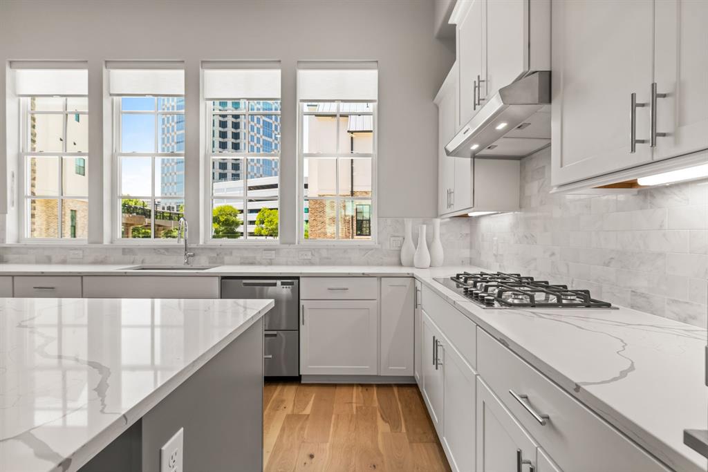5446 Patterson Court Irving, TX 75039 - Photo 12 of 40 a kitchen with stainless steel appliances a stove a sink and a window