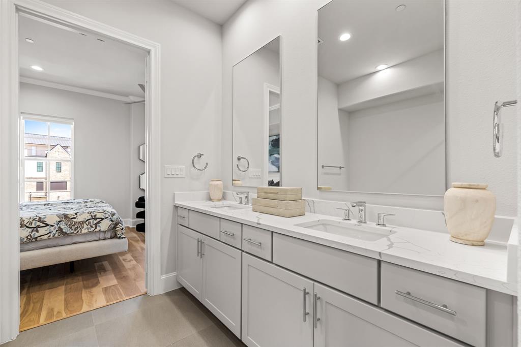 5446 Patterson Court Irving, TX 75039 - Photo 23 of 40 a en suite bathroom with double sink and a mirror