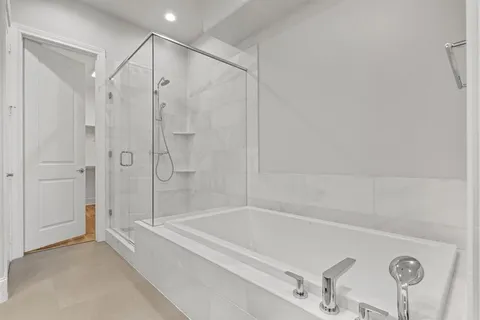 a bathroom with a bathtub and a shower