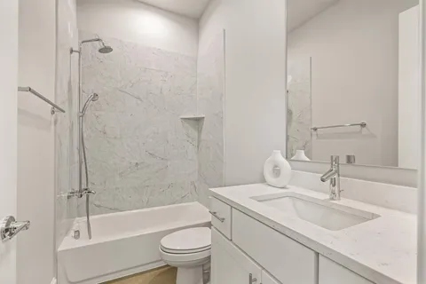 a bathroom with a sink toilet and shower