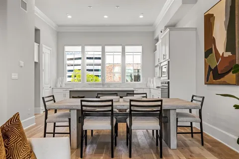 a view of a dining room with furniture and a window