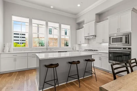 a kitchen with a stove a sink and a refrigerator