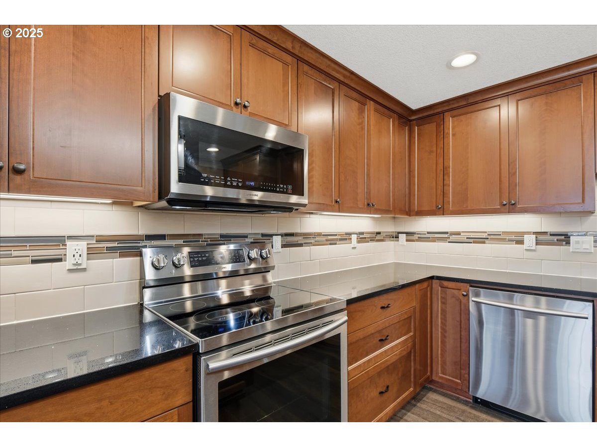2519 Northwest 13th Street Battle Ground, WA 98604 - Photo 13 of 43 a kitchen with stainless steel appliances a sink stove and microwave