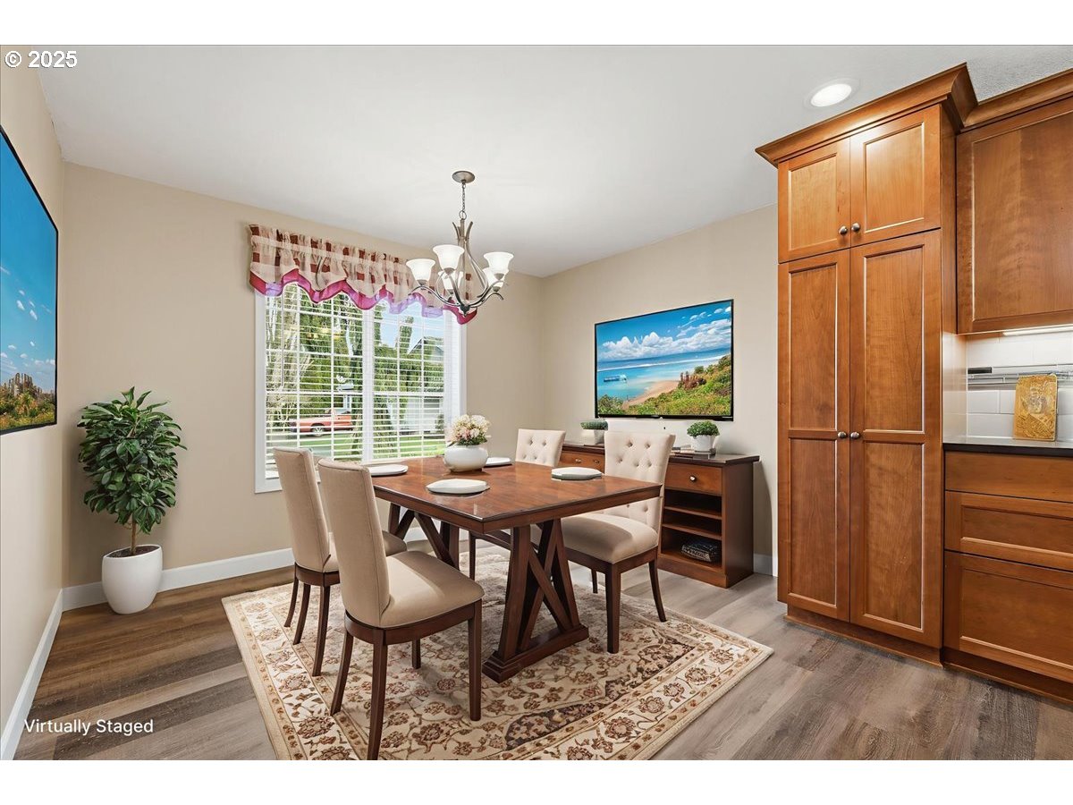 2519 Northwest 13th Street Battle Ground, WA 98604 - Photo 16 of 43 a dining room with furniture potted plants and wooden floor