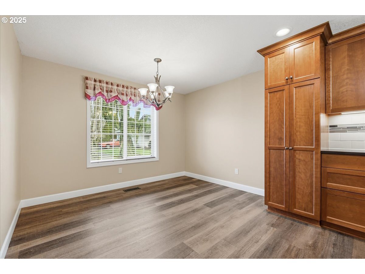 2519 Northwest 13th Street Battle Ground, WA 98604 - Photo 17 of 43 a view of wooden floor and chandelier in a living room