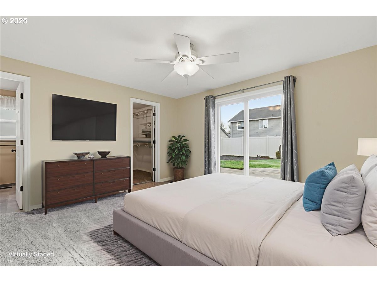 2519 Northwest 13th Street Battle Ground, WA 98604 - Photo 18 of 43 a bedroom with a bed and a flat screen tv on dresser