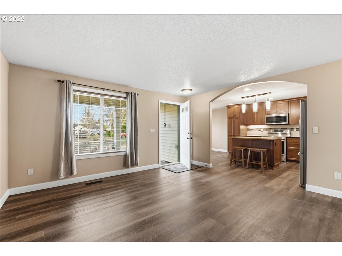 2519 Northwest 13th Street Battle Ground, WA 98604 - Photo 6 of 43 a view of an empty room with wooden floor and a window