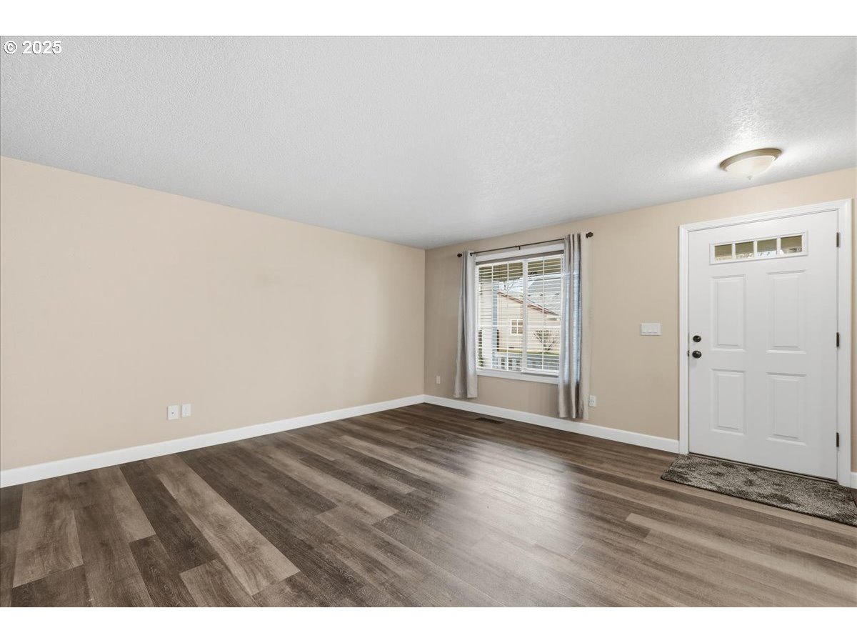 2519 Northwest 13th Street Battle Ground, WA 98604 - Photo 7 of 43 a view of an empty room with wooden floor and window