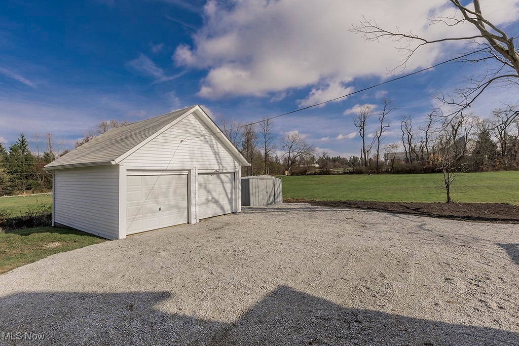 12447 Chillicothe Road Chesterland, OH 44026 - Photo 34 of 42 Garage featuring a lawn