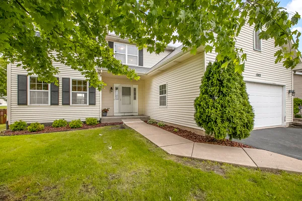a view of a house with a yard and sitting area