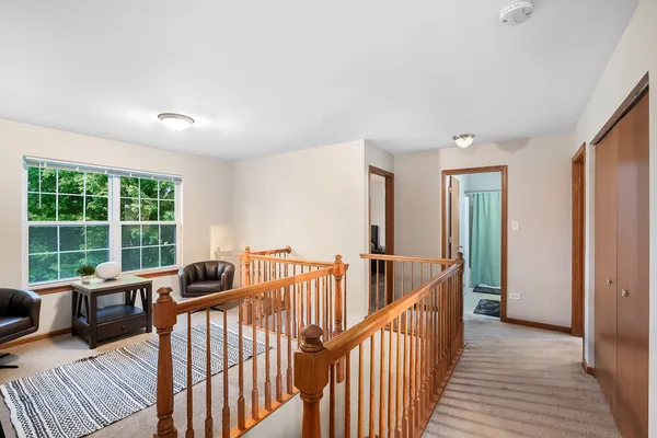 a view of a hallway with furniture and floor to ceiling window