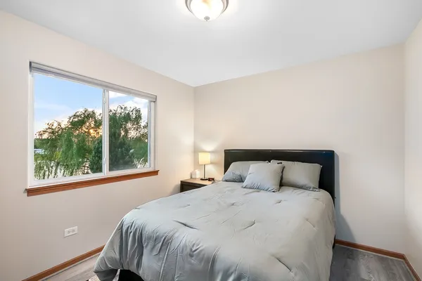 a bedroom with a large bed and a large window