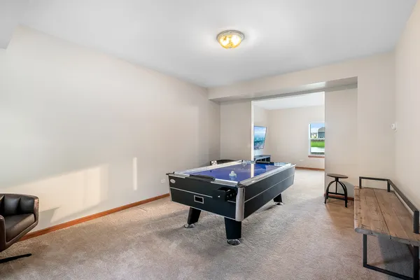 a room with furniture and air hockey table