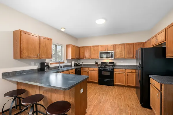 a kitchen with stainless steel appliances granite countertop a stove refrigerator sink and cabinets