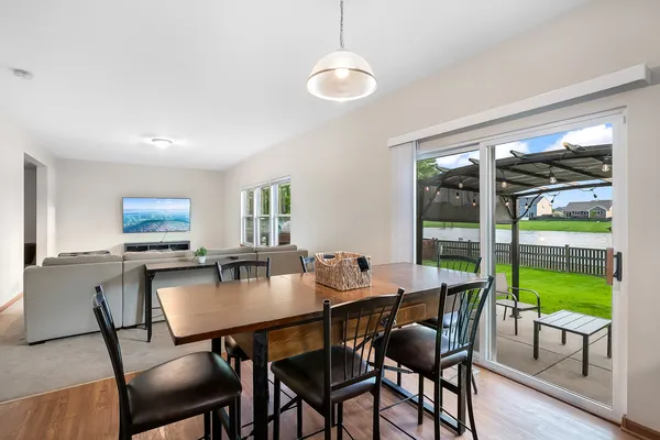 a dining room with furniture and wooden floor