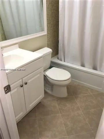 a bathroom with a toilet a sink and a mirror