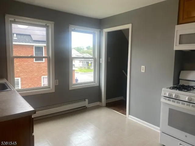 a kitchen with a stove and a window