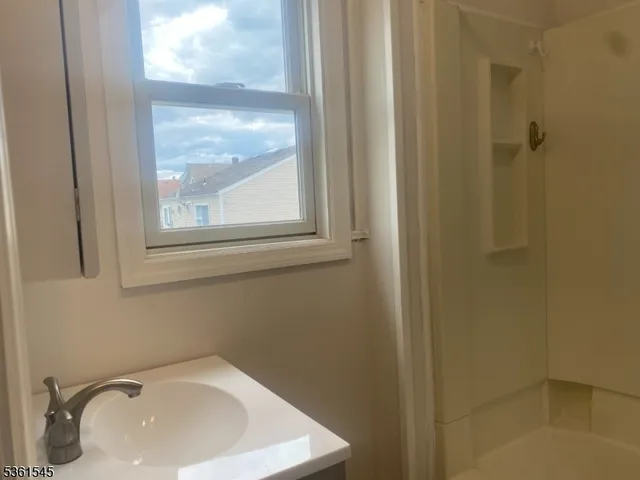a bathroom with a sink and a window