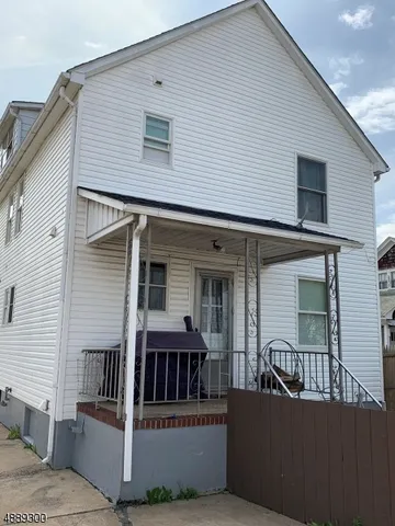 a view of a house with a small deck