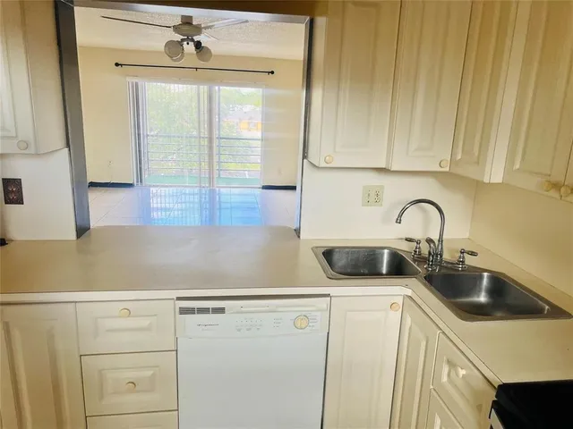 a kitchen with stainless steel appliances a stove a microwave sink and cabinets