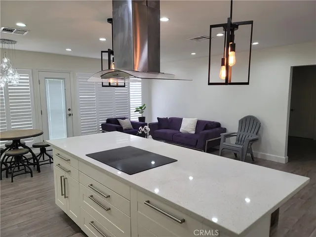 a kitchen with a table chairs and a refrigerator