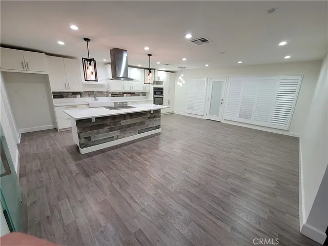 a view of kitchen with sink stainless steel appliances and cabinets