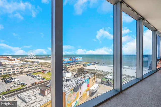 a view of a glass door with a floor to ceiling window next to a yard