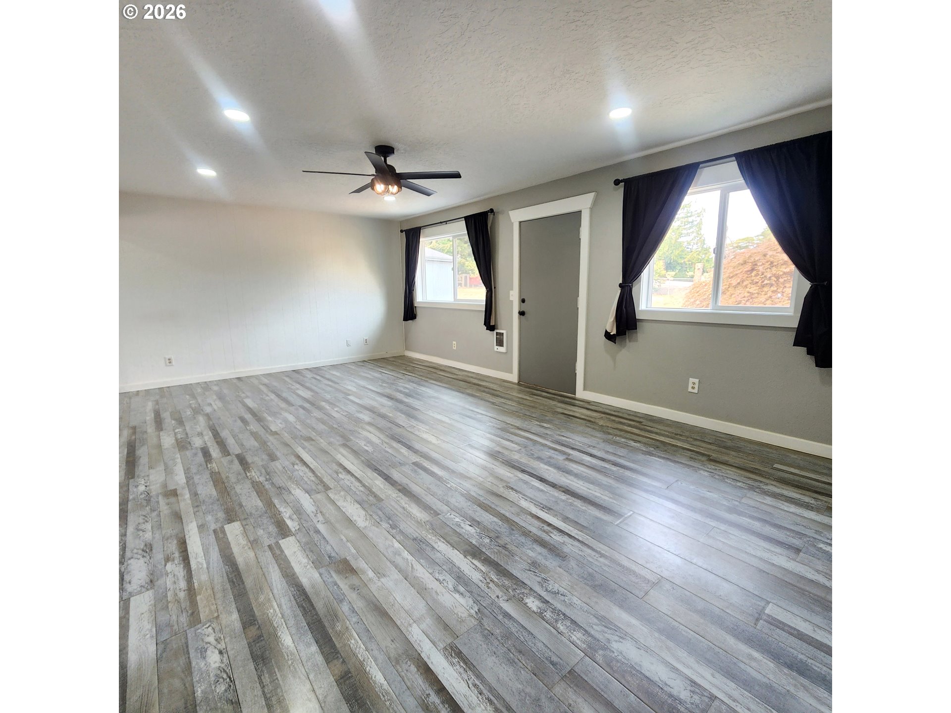 54047 West Lane Road Scappoose, OR 97056 - Photo 2 of 44 a view of empty room with wooden floor and fan