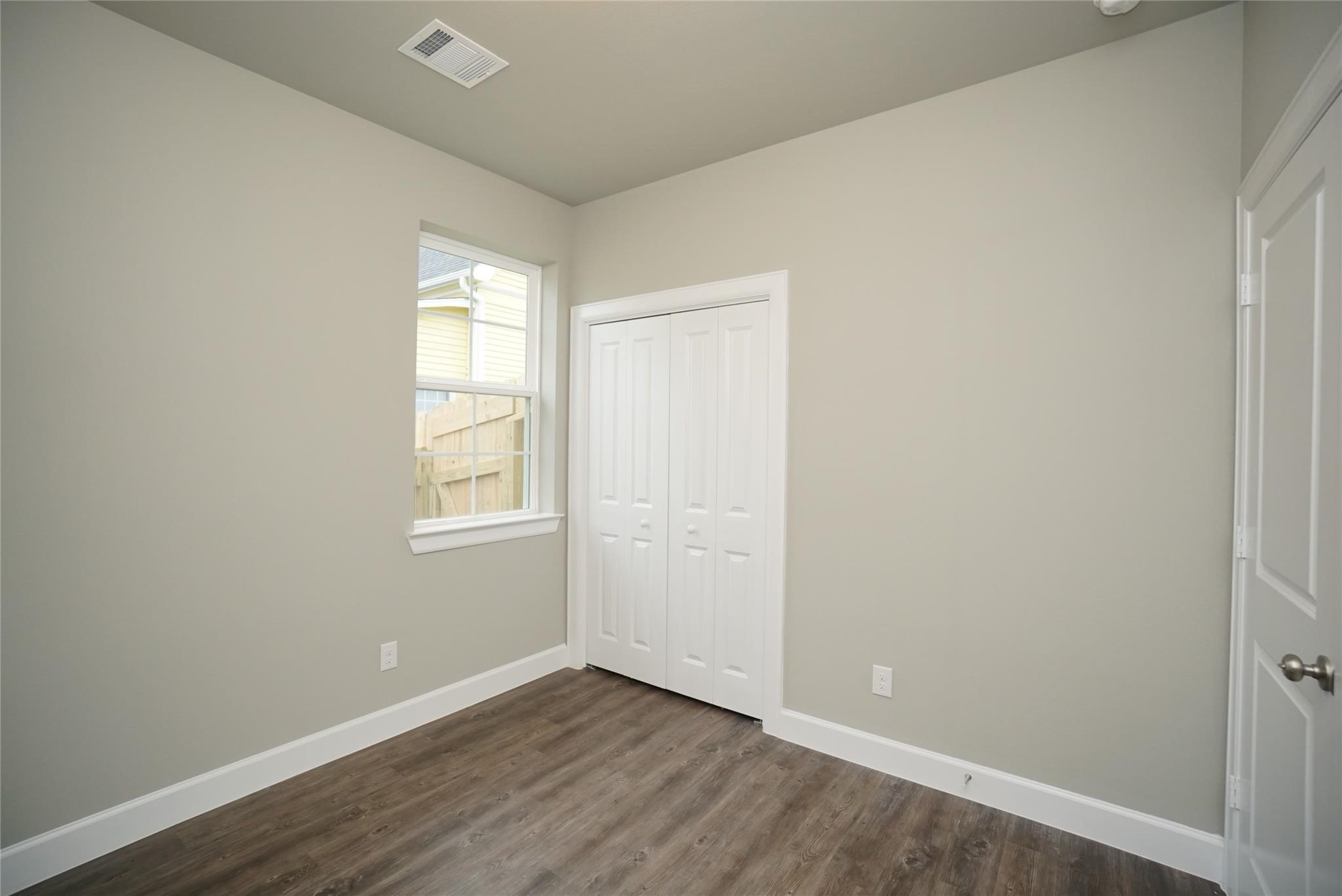 1137 4th Street Rosenberg, TX 77471 - Photo 10 of 16 an empty room with wooden floor and windows