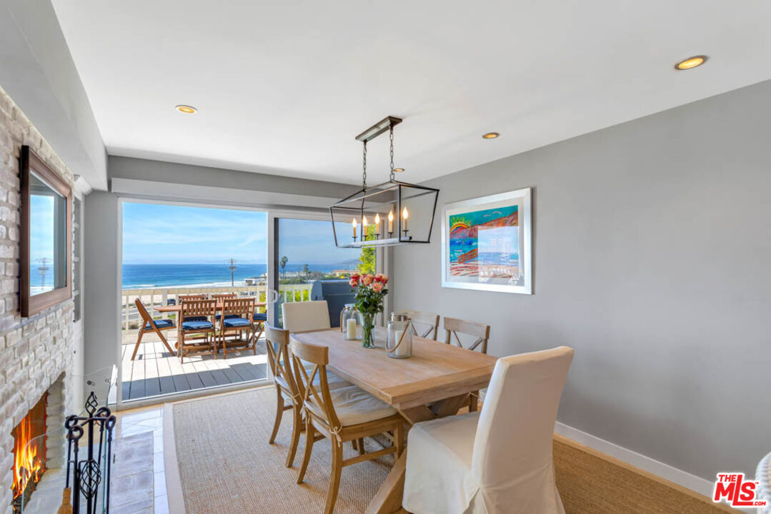 6439 Surfside Way Malibu, CA 90265 - Photo 13 of 32 a dining room with furniture a chandelier and window