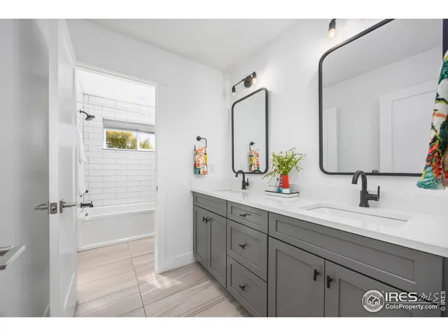 a bathroom with a double vanity sink and mirror