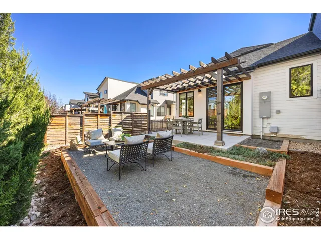 a view of a house with backyard porch and sitting area