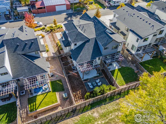 an aerial view of a house with swimming pool and outdoor seating