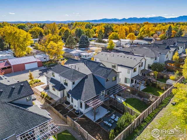 an aerial view of residential houses with outdoor space