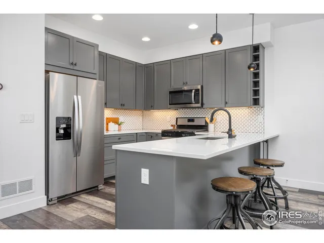 a kitchen with stainless steel appliances a refrigerator stove microwave and sink