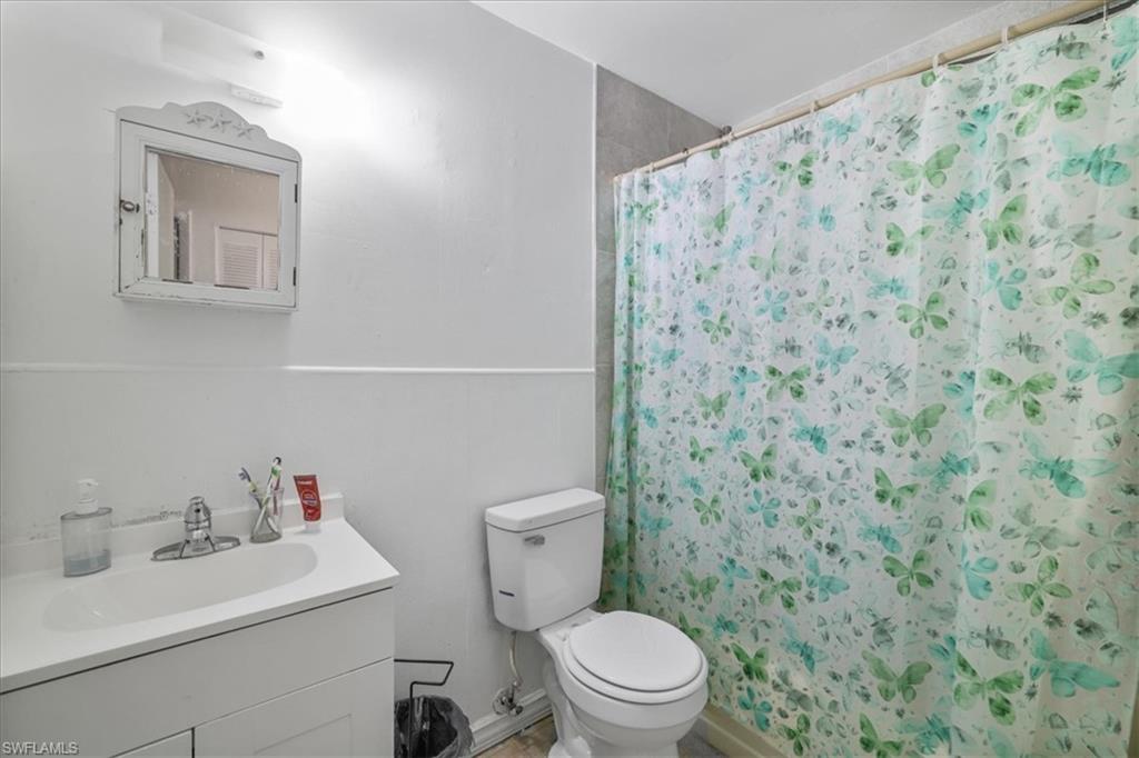 4077 South Edgewater Circle LaBelle, FL 33935 - Photo 13 of 30 a bathroom with a toilet sink and mirror