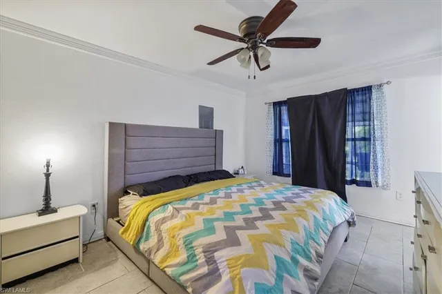 a bed room with a bed and a chandelier