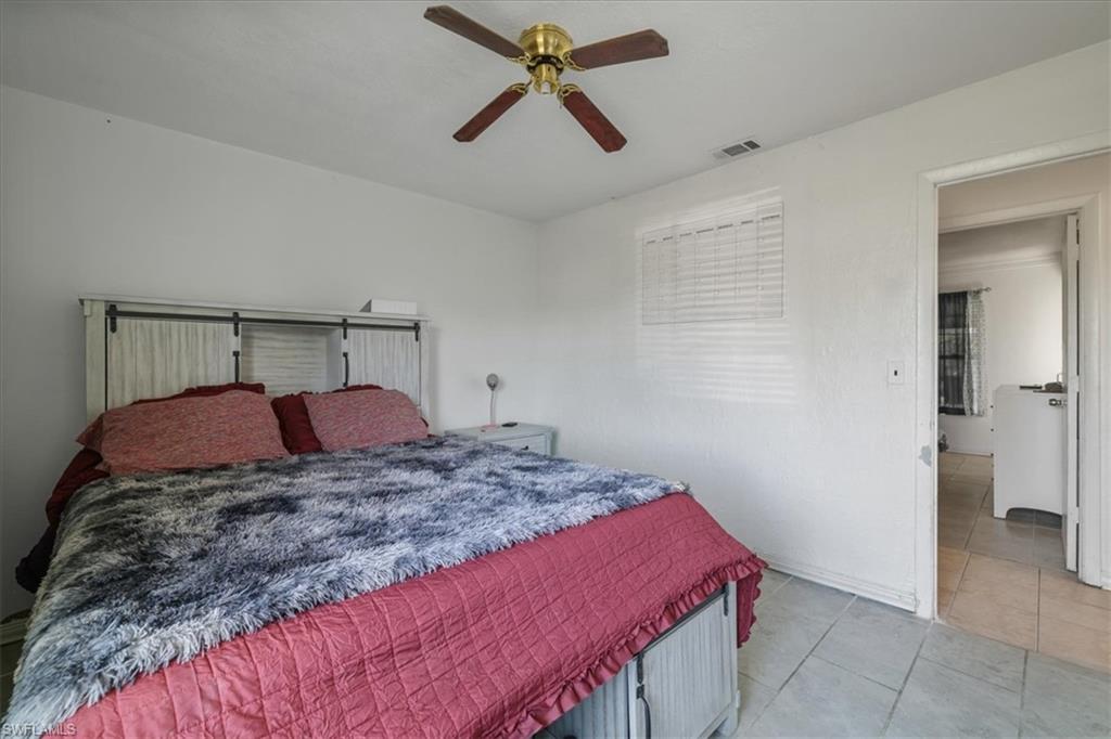 4077 South Edgewater Circle LaBelle, FL 33935 - Photo 16 of 30 a bedroom with a bed and a chandelier