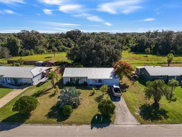 an aerial view of a house with a garden and lake view