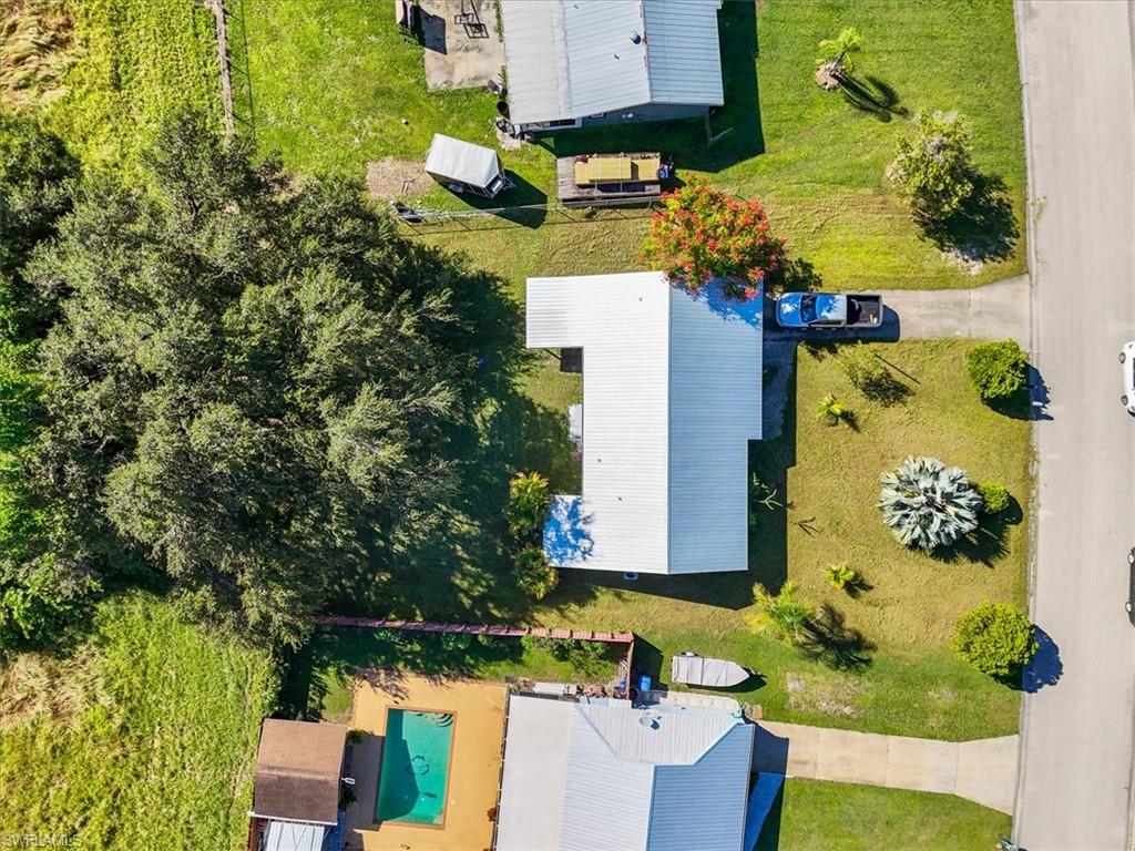 4077 South Edgewater Circle LaBelle, FL 33935 - Photo 22 of 30 an aerial view of a house with a yard swimming pool and outdoor seating
