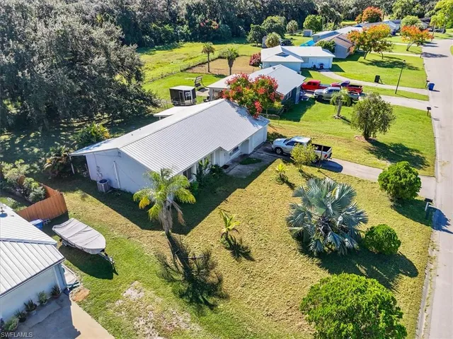 an aerial view of residential houses with outdoor space and street view