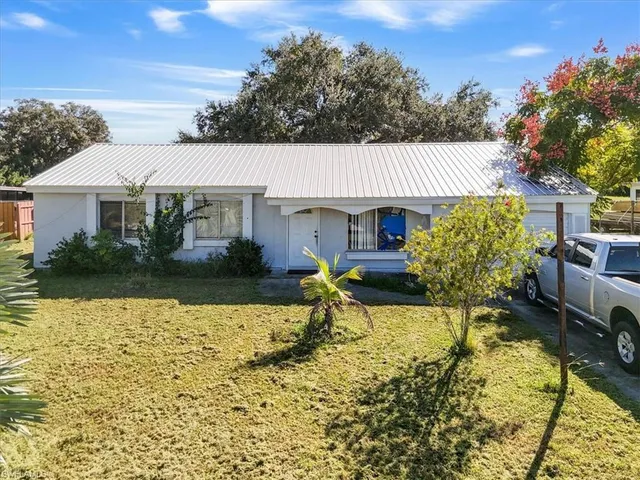 an aerial view of house with yard swimming pool and outdoor seating