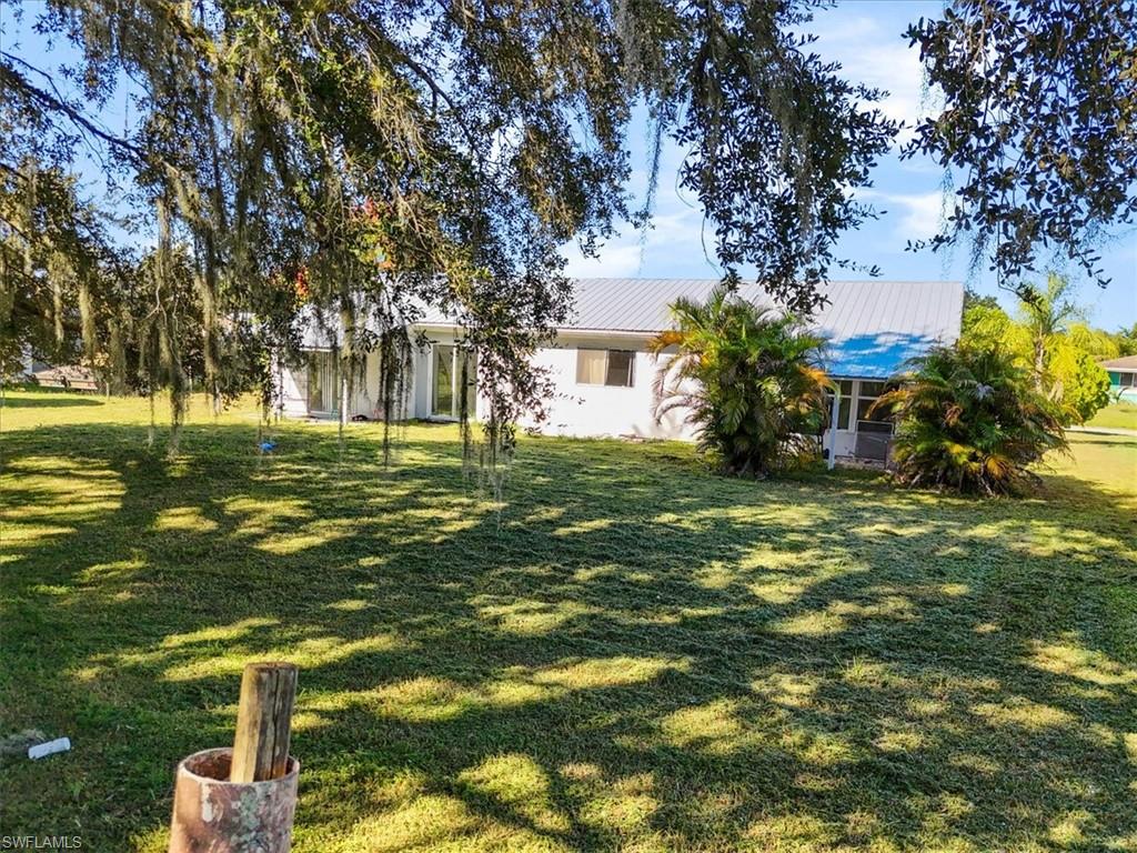4077 South Edgewater Circle LaBelle, FL 33935 - Photo 30 of 30 a view of a big yard with plants and large trees