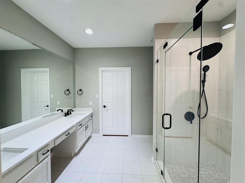 1912 Signal Ridge Place Rockwall, TX 75032 - Photo 11 of 21 a large bathroom with a double vanity sink mirror and shower