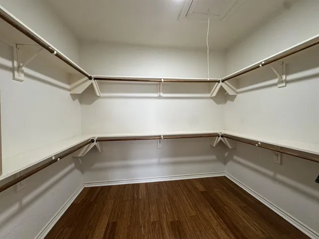 a view of a room with wooden floor