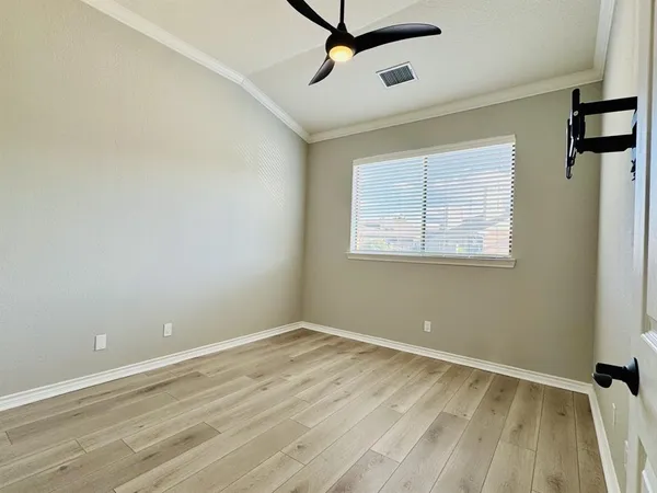 a view of a room with wooden floor and windows