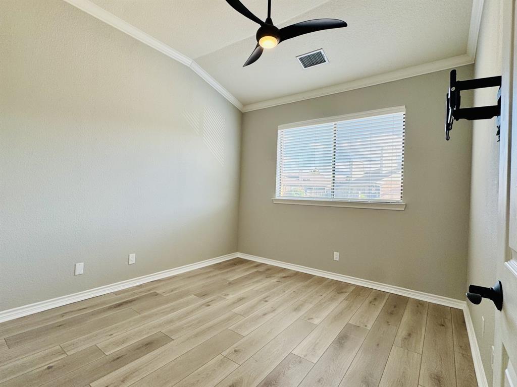 1912 Signal Ridge Place Rockwall, TX 75032 - Photo 14 of 21 a view of a room with wooden floor and windows