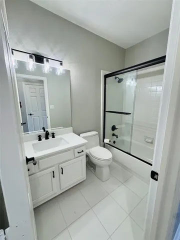 a bathroom with a double vanity sink mirror and toilet